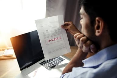 Overdue credit card bill statement on a desk